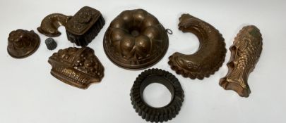 A collection of jelly moulds comprising, a large circular copper jelly mould with tinned interior,