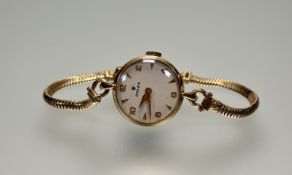A Vintage ladys 9ct gold Rolex manual wind wristwatch with white enamel dial with baton and arabic