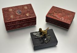 A Chinese red laqured box, with inlaid carved stones to cover (one missing), and a chinese red