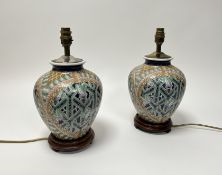 A pair of enamelled ceramic vases of bulbous form with polychrome decoration, later converted to