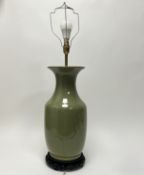 A Mid-Century Chinese sage-green glazed porcelain table lamp raised on a carved wooden stand (plug