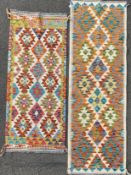 A set of two kilim rugs, each with repeating geometric diamond and triangle motifs to centre panels,