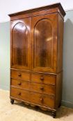 A 19th century inlaid mahogany linen press, with moulded cornice over twin inset arched panel