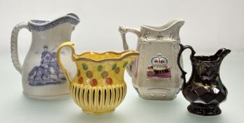 A collection of various pitchers comprising, a commemorative Jubilee pitcher with moulded decoration