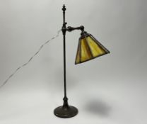 An early 20thc brass Arts and Crafts table lamp with slag glass shade and a cream pleated shade,