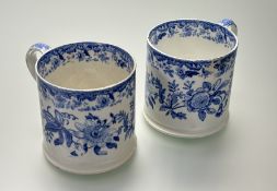 A pair of large blue and white transfer printed mugs, decorated with a floral garland band, crack