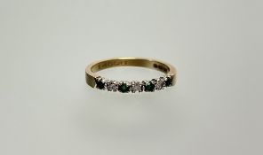A 9ct gold ring set three round brilliant cut diamonds approximately 0.05ct flanked by four round