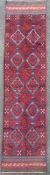 A hand-knotted kilim runner, central panel with repeating geometric diamond and square motifs,