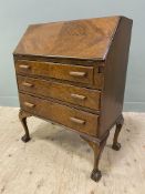 An early 20th century stained oak bureau, with fall-front enclosing a fitted interior of pigeon