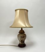A Rochamp table light of ginger jar form, with painted and gilded flowering plants, raised on a