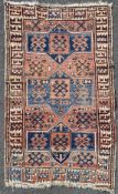 A hand-knotted Kazak/ Iznik rug, central panel with three blue medallions surrounded by stylized