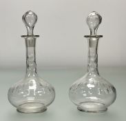A pair of glass cut bublous decanters with a circular cut band to body and neck with original
