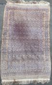 A hand-woven Moroccan Berber rug, central panel with repeating geometric diamond motifs, enclosed