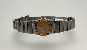 A ladys stainless steel and yellow metal Constellation quartz wrist watch with gilt dial and gilt