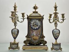 A 19thc French three piece brass clock set comprising an oval mantle clock raised on a giltwood