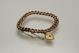 An Edwardian 15ct gold curb link bracelet with clip fastening and engraved yellow metal heart and