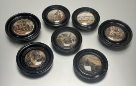 A collection of seven 19thc Prattware circular back ebonised framed pot lids, each depicting various