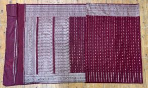 An Indian plum silk Sari of traditional design with one long side and a lower section of the other