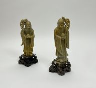 A pair of 20thc Chinese carved soapstone figures of Shou Lao, moulded holding a staff and peach,