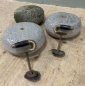 A set of three granite curling stones, consisting of a pair of highly polished stones with