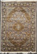 A hand-knotted Persian Qom (Ghom) rug, central medallion surrounded by intricately woven stylized