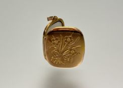 A 9ct gold locket with engraved front and twin interior panels: l. x 2.5cm 3.73g