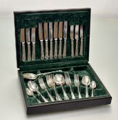 An oak canteen containing a suite of Sheffield plated and stainless steel-bladed flatware for six