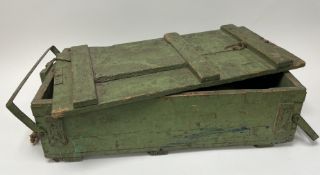 A large military style wooden crate in green distressed paint with twin wire and canvas handles (