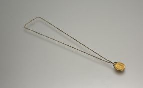 A George V gold half sovereign 1912 mounted in 9ct gold mount on 9ct gold trace link chain with ring
