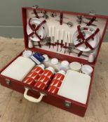 A 1960s Brexton picnic set, the red case fitted with cutlery, plates, cups, thermos flasks and