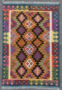 A hand-knotted Kilim rug, central panel with four stylized flowerheads surrounded by geometric and