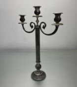A moulded silver-toned metal three-armed candelabra with scroll and beaded decoration (h. 51cm)