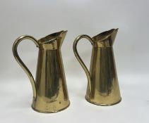 A pair of late 19thc John Marston brass water pitchers, both with shaped spouts and large swing