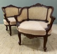 A pair of 20th century French walnut bergere armchairs, arched and carved top rail with bergere