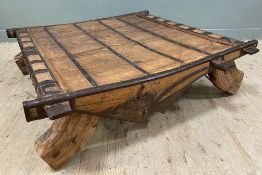 An antique Indian hardwood and wrought iron mounted bullock cart, converted to coffee table, with