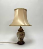 A Rochamp table light of ginger jar form, with painted and gilded flowering plants, raised on a