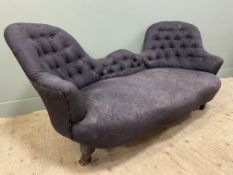 An Edwardian mahogany framed bedroom sofa, with curved button-back and arms, upholstered in a