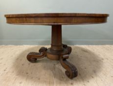 An impressive Victorian mahogany centre table, circular moulded tilt-top raised on a central