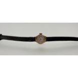 A 9ct gold Regency wristwatch with arabic numerals and baton hour markers on brown strap: d. x 1cm