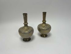 A pair of early 20thc Indian brass vases of bulbous form, etched with figures and foliate detail