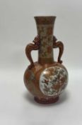 A Japanese Kutani porcelain vase, with traditional scenes to body and shaped dragon twin handles