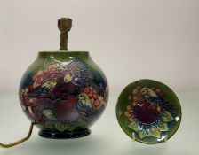A Moorcroft Pottery Finch Bird and fruit pattern trinket dish (crack/loss to edge) together with