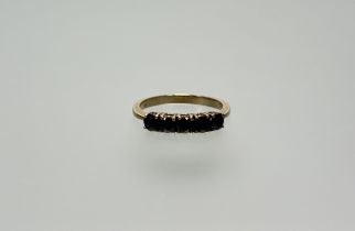 A 9ct gold ring set five circualr dark blue sapphires each stone approximately 0.20ct P 2.32g