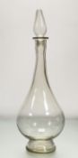 A late 19thc/Early 20thc Pharmacy clear glass display bottle of balsuter form with teardrop shaped