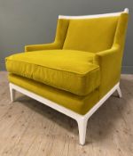 A contemporary wingback armchair, with curved top and square arms, upholstered in a yellow velvet