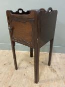 A 19th century mahogany bedside cabinet, with gallery sides to top with shaped handles, over inset