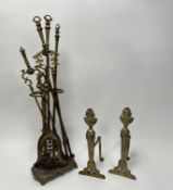 A cast brass fireplace companion set, comprising an ash pan, two pairs of fire tongs, and a poker,
