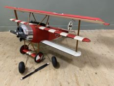 A modern RC model airplane, with WWI German livery 'Fokker Dr.1 Red Baron' kit plane, with triple