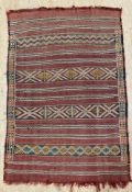 An antique hand-knotted kilim rug, with horizontal stripes and repeating geometric design, deep