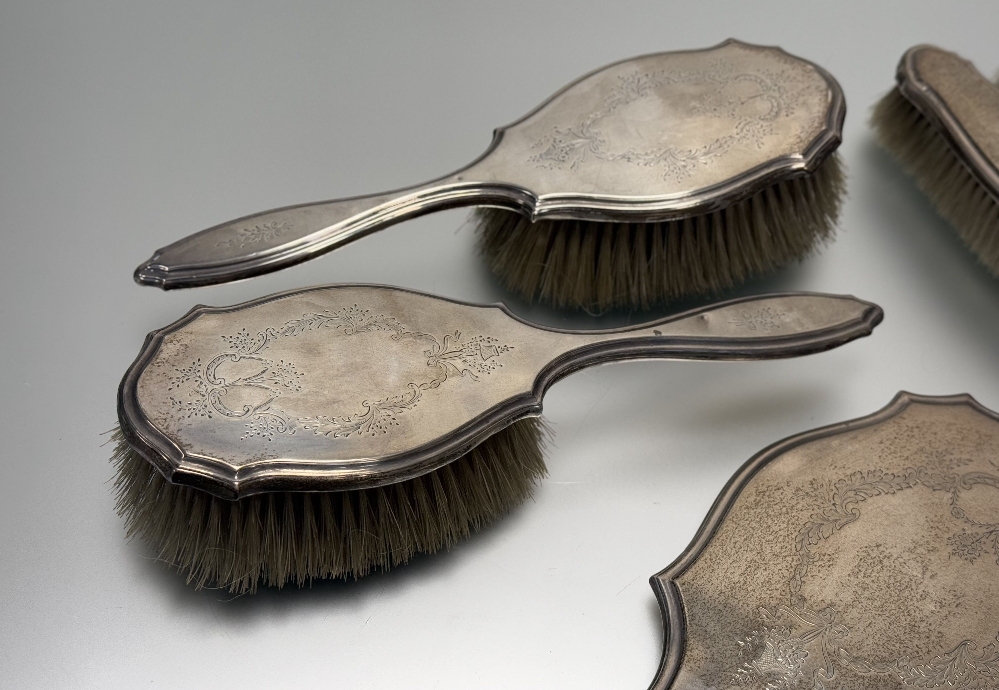 A London silver five-piece ribbon and floral swag engraved dressing set to include a hand mirror: l. - Image 3 of 6